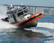 US Coast Guard shoots out migrant boat engine in high speed chase