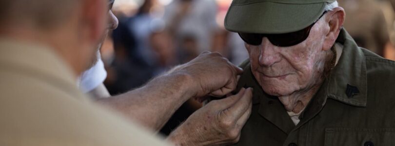 He was bayoneted in Guam. Shot on Iwo. Now, at 100, he is a sergeant.
