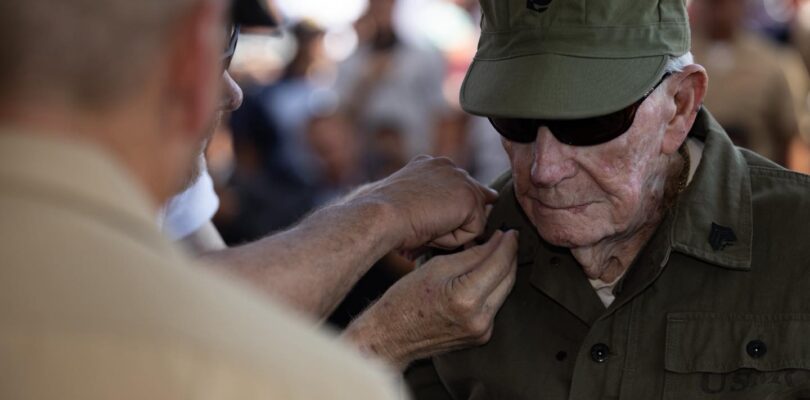 He was bayoneted in Guam. Shot on Iwo. Now, at 100, he is a sergeant.