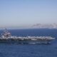 Iran puts ‘fingers on trigger’ as US armada arrives in Middle East