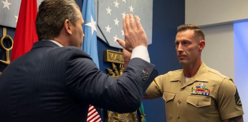 Veteran who lost both of his legs in combat reenlists in the Marine Corps