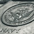 Detailed view of the United States Navy emblem on a monument in Washington D.C., showcasing naval heritage.