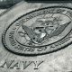 Detailed view of the United States Navy emblem on a monument in Washington D.C., showcasing naval heritage.